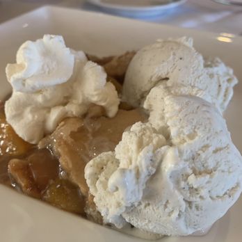 The Creek Restaurant - Peach cobbler with vanilla ice cream - New American Near Me - Boerne, Texas The Creek Restaurant - Peach cobbler with vanilla ice cream - New American Near Me - Boerne, Texas