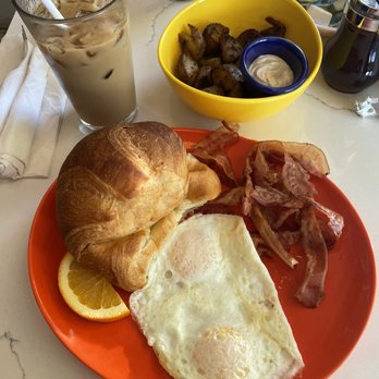 Banana Cafe - Over easy eggs/bacon/croissant with a side of breakfast potatoes - French Near Me - Key West, Florida Banana Cafe - Over easy eggs/bacon/croissant with a side of breakfast potatoes - French Near Me - Key West, Florida