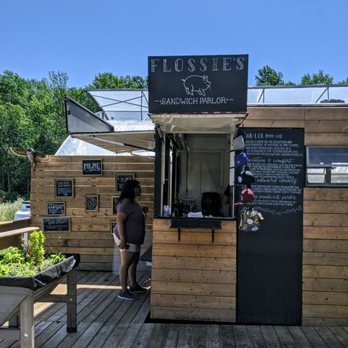 Flossie's Sandwich Parlor - a woman standing at the counter - Food Stands Near Me - Hillier, Ontario