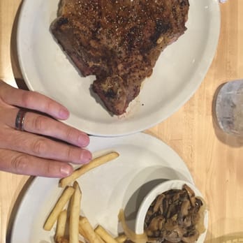 Sodolaks Beefmasters Restaurant - A "small" T-bone steak, with mushrooms and onions on the side with fries. - American Near Me - Bryan, Texas Sodolaks Beefmasters Restaurant - A "small" T-bone steak, with mushrooms and onions on the side with fries. - American Near Me - Bryan, Texas