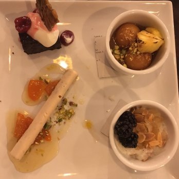 Ghee Indian Kitchen - Tasting menu dessert platter with ice cream stick, rice pudding, spongy honey doughnuts and chocolate cake. - Indian Near Me - Miami, Florida