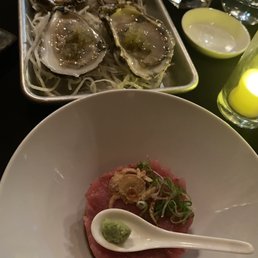Tuna tartare and fresh oysters with cilantro relish and scallions in ponzu sauce.