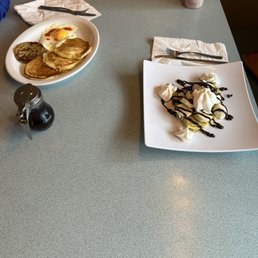 Banana and Nutella crêpe with chocolate and whip whipped cream on top. Also, pancakes with syrup, sunny side up egg, and sausage. Banana and Nutella crêpe with chocolate and whip whipped cream on top. Also, pancakes with syrup, sunny side up egg, and sausage.