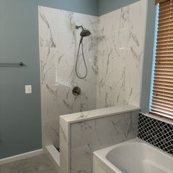 Click Construction and Remodeling - Pretty stone and tile waiting on the shower door.