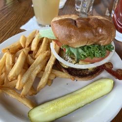 Madeline's Dining & Events - Bacon burger, side of fries & pickle.