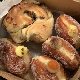 From top left clockwise: Green onion savory brioche, Banana Cream Malasada, Kona coffee, guava, and passion fruit (with the seeds). From top left clockwise: Green onion savory brioche, Banana Cream Malasada, Kona coffee, guava, and passion fruit (with the seeds).