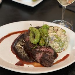Cajun Rubbed Hangar Steak over Barbecue Demi Glacé, topped with Fried Shishito Peppers, served with Warm Potato Salad with Peas & Carrots