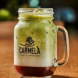 Carmela Coffee - Pompano Beach - Iced matcha latte at Carmela Coffee Pompano. Made with premium matcha, milk, and ice, this refreshing drink is a favorite for...