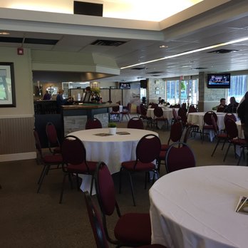 Bear Creek Golf Club - tables with white tablecloths and red chairs - Golf Near Me - Utopia, Ontario