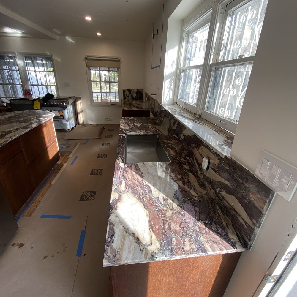 Marble kitchen counter with backsplash and window sill
