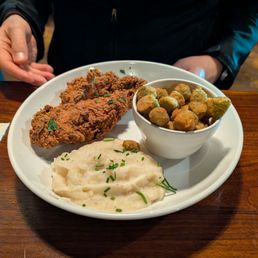 Chicken dinner with mashed potatoes and fried okra.