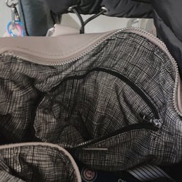 Inside zippered pocket & 2 lined pockets. Cute interior in contrast to the pink of the purse.