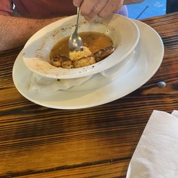 What was left of shrimp and grits. Small portion. Left over broth . One scoop of grits. What was left of shrimp and grits. Small portion. Left over broth . One scoop of grits.