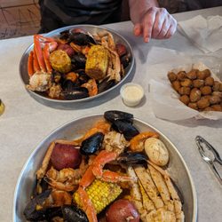 The Juicy Crawfish - Two orders of the daily special S1, one had an extra crab cluster added. Medium Special seasoning. Plus an order.of fried okra. Yum!