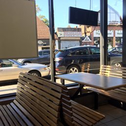 tables and benches in front of a window