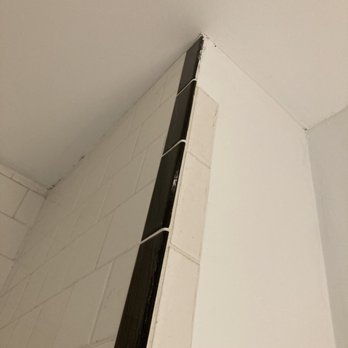 Gerhardt Drywall & Painting - Here's where they broke off a tile while removing the ceiling drywall. They didn't fix the tile, and they  took it when they left. - Drywall Installation & Repair Near Me