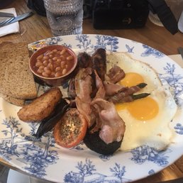 Sausage, bacon wrapped asparagus, black blood pudding, eggs, hash browns, pancakes, fruit and grilled banana. All delicious.