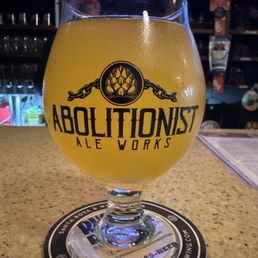 A Country Roads cider in an Abolitionist branded glass A Country Roads cider in an Abolitionist branded glass