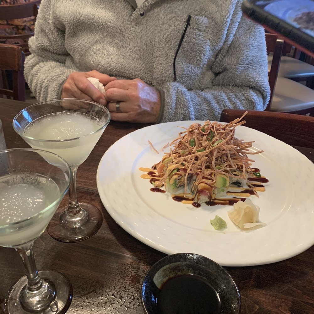 a man sitting at a table with a plate of food a man sitting at a table with a plate of food