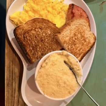 Two Chicks Café - CBD - Soft scrambled eggs, ham steak, Gouda grits, sour dough toast - Breakfast & Brunch Near Me - New Orleans, Louisiana Two Chicks Café - CBD - Soft scrambled eggs, ham steak, Gouda grits, sour dough toast - Breakfast & Brunch Near Me - New Orleans, Louisiana