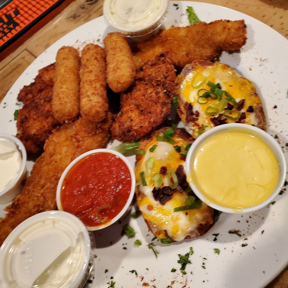 Briny Irish Pub - Sampler app. Mozzarella sticks, potato skins, fish sticks, chicken tenders. - American Near Me - Pompano Beach, Florida Briny Irish Pub - Sampler app. Mozzarella sticks, potato skins, fish sticks, chicken tenders. - American Near Me - Pompano Beach, Florida
