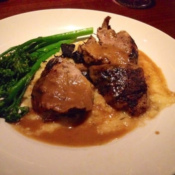 Seasons 52 - Pork tenderloin on a bed of butternut squash polenta served with broccolitini. - New American Near Me - Memphis, Tennessee Seasons 52 - Pork tenderloin on a bed of butternut squash polenta served with broccolitini. - New American Near Me - Memphis, Tennessee