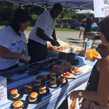 Delaware Burger Battle - a woman serving burgers at a table - Festivals Near Me - Wilmington, Delaware