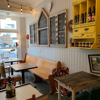 Café Maudit-Bonheur - a table and benches in a cafe - Cafes Near Me - Montreal, Quebec Café Maudit-Bonheur - a table and benches in a cafe - Cafes Near Me - Montreal, Quebec