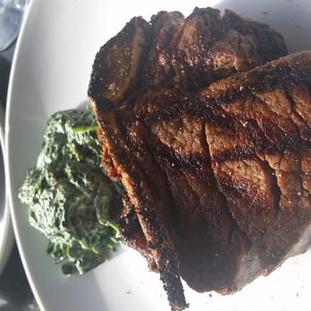 Prime - Bone-in filet mignon with side order of cream spinach [apologies, while Yelp troubleshoots why photos are posted upside down | sideways] - American Near Me - Huntington, New York