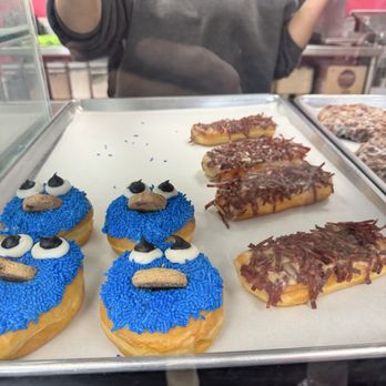 Frosted Donuts - Cookie Monster and maple bacon long John - Donuts Near Me - Tinley Park, Illinois