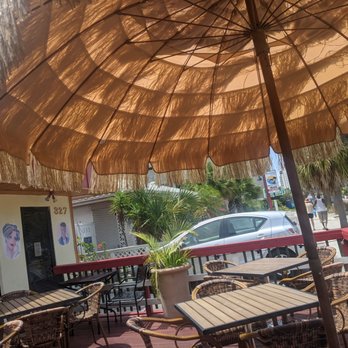 King's Pizza & Grill - a patio with tables and chairs and an umbrella - Pizza Near Me - Clearwater Beach, Florida King's Pizza & Grill - a patio with tables and chairs and an umbrella - Pizza Near Me - Clearwater Beach, Florida