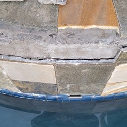 Erik Johnson Tile - Our spa tile literally falling off the wall after cracking. No thin set on the back of the tiles- hollow when we knock on them.