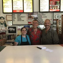 three people standing in front of a counter