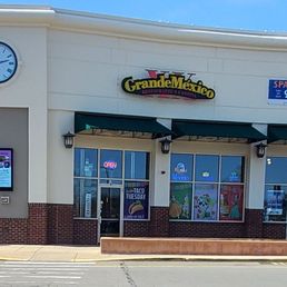 the front of a restaurant with a clock the front of a restaurant with a clock