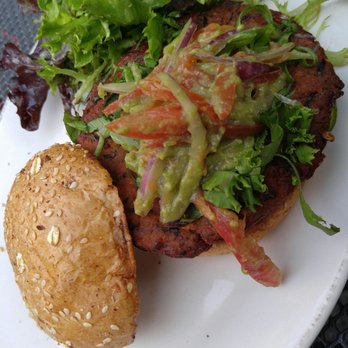 The Local - House made veggie burger with cheese filled in the middle and an onion, tomatoe, avocado spread on top, with a field of greens side salad. - Irish Pub Near Me - Minneapolis, Minnesota