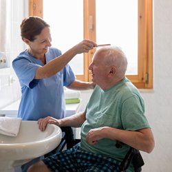 SeniCare Plus - Home Health Aide helping a senior with their personal care by combing his hair