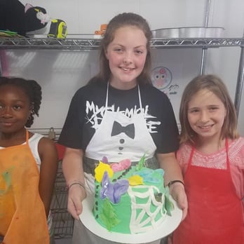 The Cake Mix - three girls holding a cake - Cooking Schools Near Me - Rincon, Georgia The Cake Mix - three girls holding a cake - Cooking Schools Near Me - Rincon, Georgia