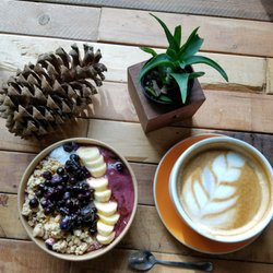 Goodwin's Organics Cafe - Orange latte with and acai bowl with blueberries, bananas, coconut shavings, granola and honey.