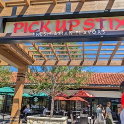 Pick Up Stix Fresh Asian Flavors - Pleasant storefront with tables outside and inside.