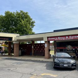 Garry's Grill & Catering - Restaurant on right, outdoor seating on left.