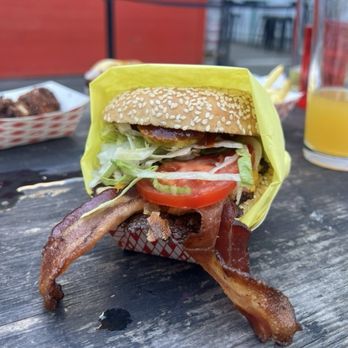 Lovely's - the westerner: american cheese, bacon, crispy shallot, pickle, lettuce, tomato, bbq sauce + sesame bun = $12.50 - Burgers Near Me - Oakland, California