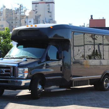 The Party Bus - a large black bus parked in a parking lot - Party Bus Rentals Near Me The Party Bus - a large black bus parked in a parking lot - Party Bus Rentals Near Me