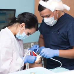 Universal Dental - Dr. Ortega working with a patient.