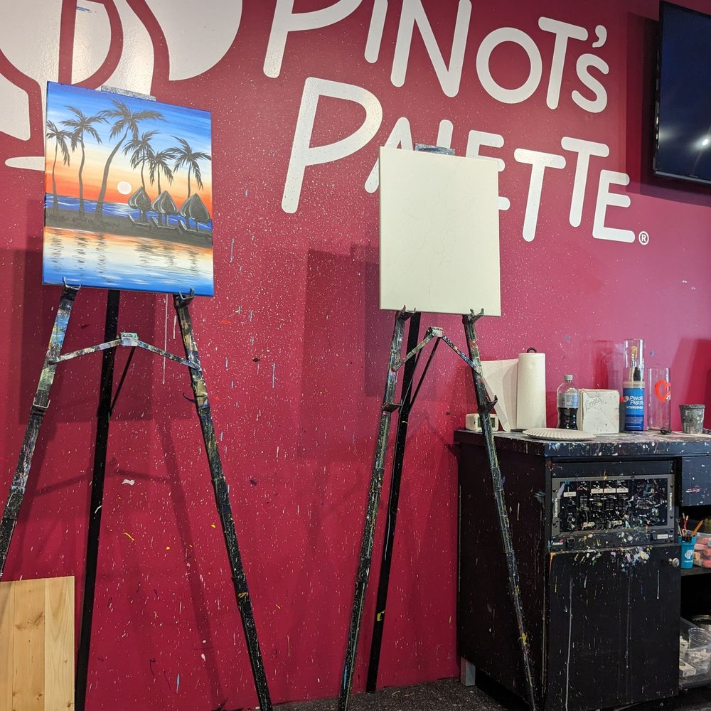 Pinot's Palette - The stage with an example of the finished painting, and the blank canvas they use to show you each step. - Party & Event Planning Near Me - Broken Arrow, Oklahoma