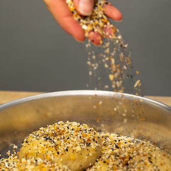 Bennington Bagel Company - a person sprinkling seeds on a bagel - Bagels Near Me - Bennington, Vermont Bennington Bagel Company - a person sprinkling seeds on a bagel - Bagels Near Me - Bennington, Vermont