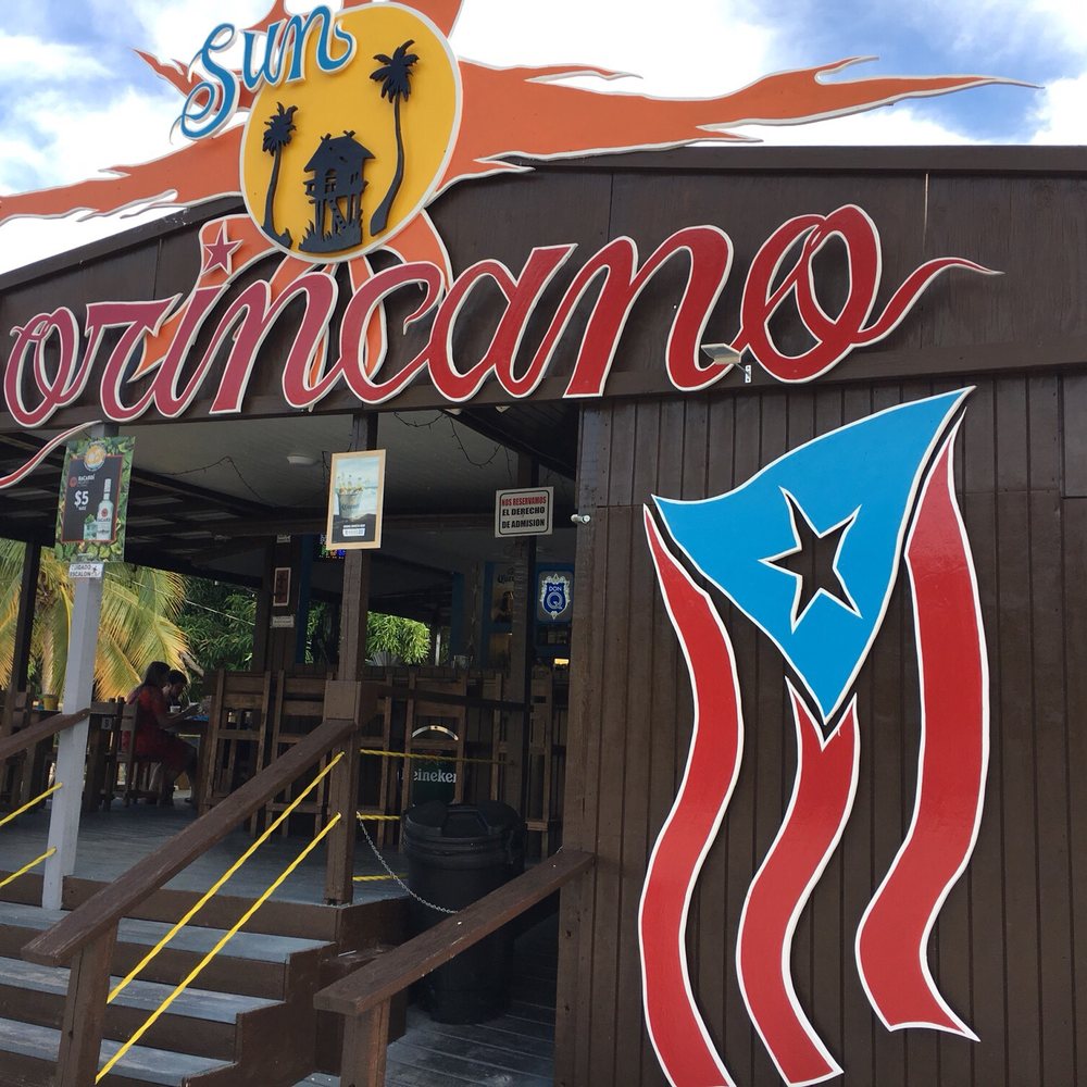 Sun Borincano - Front sign off PR-2 in coastal Ponce. Outdoor bar and tables, and adjoining indoor seating that is air-conditioned. - Tapas Bars Near Me - Ponce, Puerto Rico