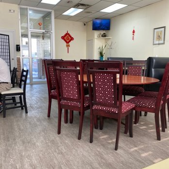 Noodleholic - a dining room with a table and chairs - Noodles Near Me - Edmonton, Alberta