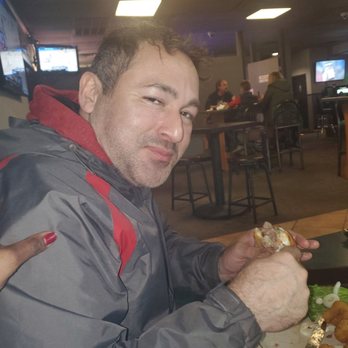 Chaser's Grill & Bar - a man eating a sandwich - Sports Bars Near Me - Effingham, Illinois
