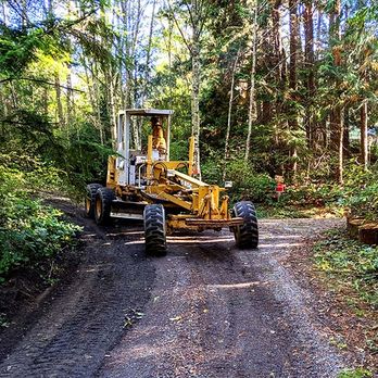 Moving Earth Excavation - a bulldozer on a dirt road in the woods - Landscaping Near Me - Port Townsend, Washington Moving Earth Excavation - a bulldozer on a dirt road in the woods - Landscaping Near Me - Port Townsend, Washington