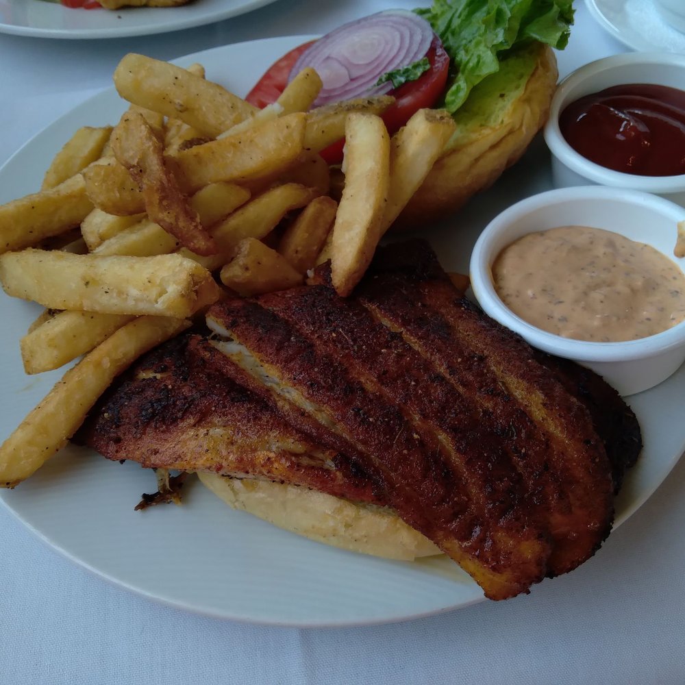 Thistle Lodge Beachfront Restaurant - Blackened grouper with fries - New American Near Me - Sanibel, Florida Thistle Lodge Beachfront Restaurant - Blackened grouper with fries - New American Near Me - Sanibel, Florida